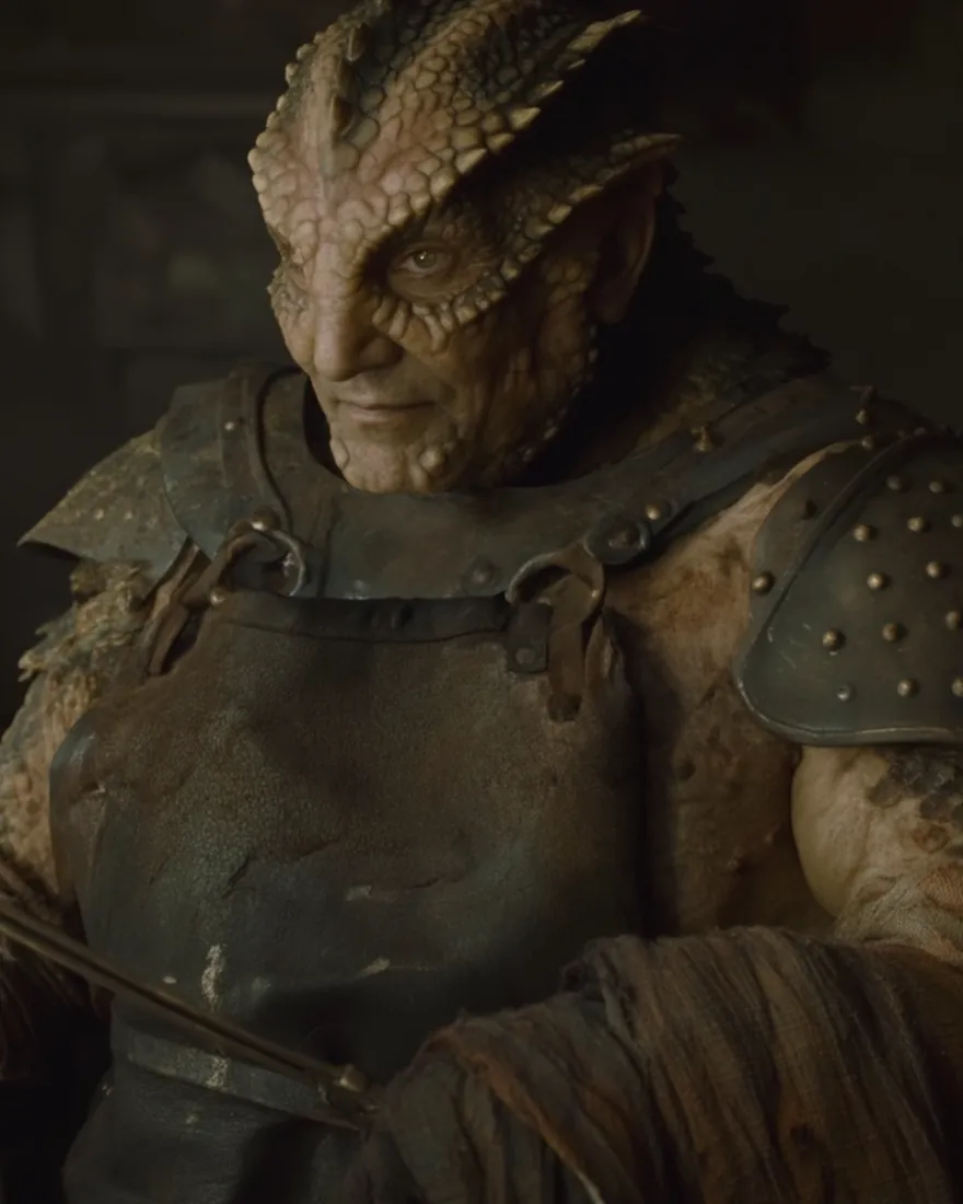 A Scan'uun master at his forge, the bumped scales running back over the skull and the fire behind him doing work no glove is wanted for.